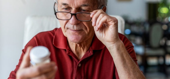 An old man looking at Prescriptions