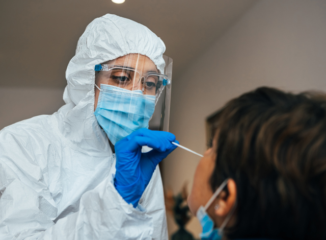 Doctor-in-PPE-Suit-Taking-a-Nasal-Swab-from-a-Person-to-test-for-Possible-Coronavirus-Infection